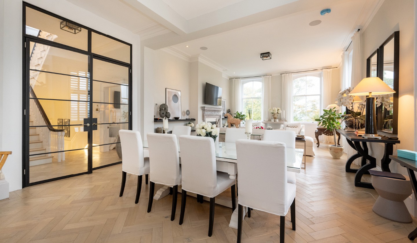Dining table with large glass black framed doors